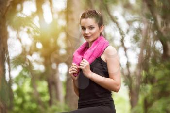 Young Woman Resting After Running In Wooded Forest Area - Training And Exercising For Trail Run Marathon Endurance - Fitness Healthy Lifestyle Concept