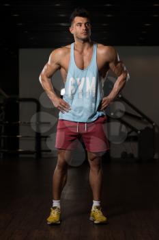 Portrait Of A Young Physically Fit Man In Blue Undershirt Showing His Well Trained Body - Muscular Athletic Bodybuilder Fitness Model Posing After Exercises