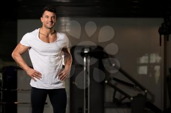 Portrait of a Young Physically Fit Man in White T-shirt Showing His Well Trained Body - Muscular Athletic Bodybuilder Fitness Model Posing After Exercises