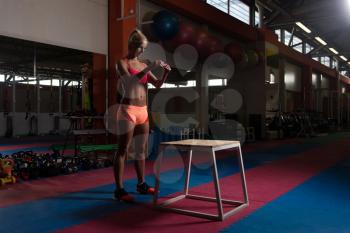 Fit Young Woman Doing Box Jumping At A Style Gym - Female Athlete Is Performing Box Jumps At Gym