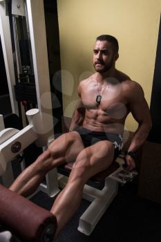Leg Exercises -  Man Doing Leg With Machine In Gym