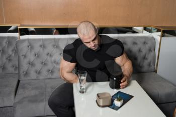 Muscular Handsome Bodybuilder With Pills And Dope For Copy Space