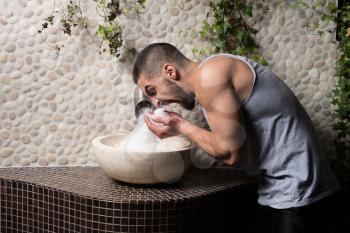 Happy Good Looking And Attractive Young Man With Muscular Body Relaxing In Sauna With White Organic Himalayan Rock Salt Spa
