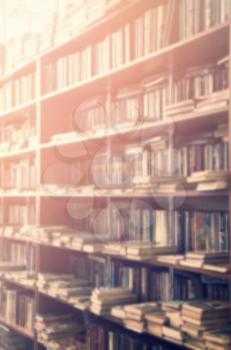 blurred bookshelf in library for your background design