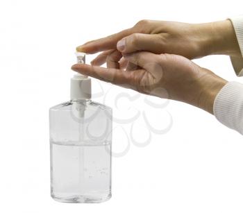 Clear bottle of hand sanitizer with two hands in use