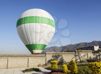 Hot air balloon being prepared for flight with Li mountains and blue sky in background