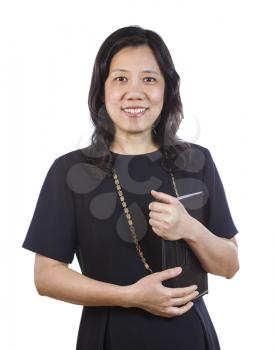 A portrait Vertical photo of a mature Asian woman wearing a dark dress while holding a folder on a white background