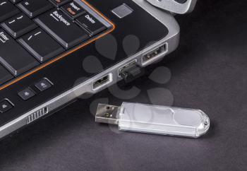 Unsecured portable USB device next to notebook computer