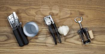 Overhead view of basic kitchen utilities with matching item for use placed on rustic wood