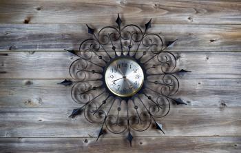 Top view of old fan star shaped clock on rustic wood 
