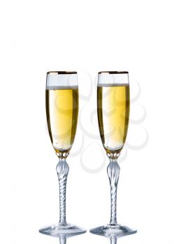 Golden champagne in elegant glasses isolated over white background with reflection 