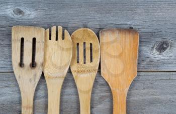 Horizontal image of old wooden cooking utensils on rustic wood 