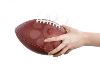 Female hand holding American football on isolated white background.