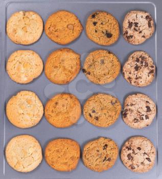 Top view of a variety of freshly baked cookies on metal baking sheet