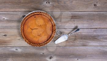 Overhead view of Pumpkin pie and spatula server on rustic table