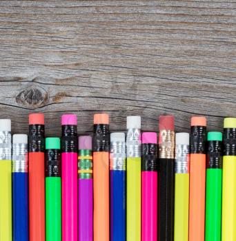 Colorful pencils on rustic wood for Back to School concept