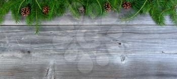 Overhead view of real fir Christmas tree branches on weathered wood  