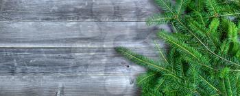 Christmas branches on weathered wood with copy space available 