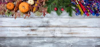 Yearend seasonal decorations in top border on rustic white wooden boards 
