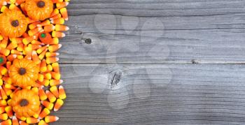 Halloween treats forming left border on weathered wood 
