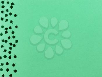 Saint Patricks Day with border of shamrocks on green background with copy space 
