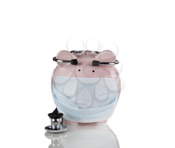 piggy bank with medical mask and stethoscope on. Financial crisis concept. Isolated on white with reflection. 