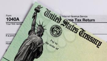 IRS refund check and tax form in close up view  