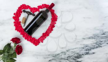 Happy Valentines Day with lovely red outline shape of large heart and romantic gifts including wine on natural marble stone background 