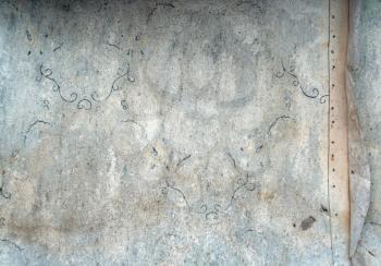 Old abandoned weathered wallpaper on outdoor wall.