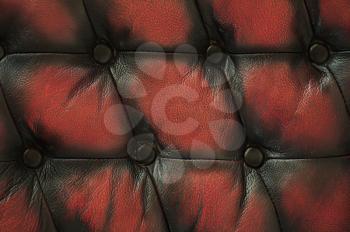 сlose up old red black luxury buttoned leather background
