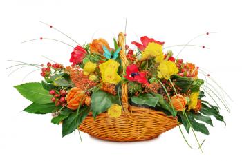 Flower bouquet arrangement centerpiece in a wicker gift basket isolated on white background.