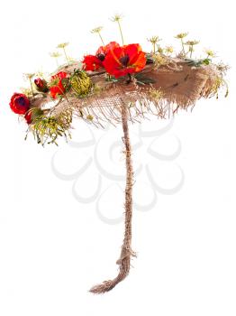 decorative umbrella of burlap, mats and artificial flowers poppy