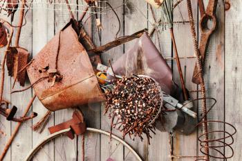 Still-life of rusty metal items on wooden background.