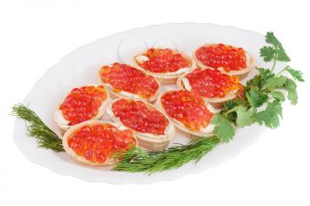 Tartlets with red caviar on plate isolated on white background. Closeup. 