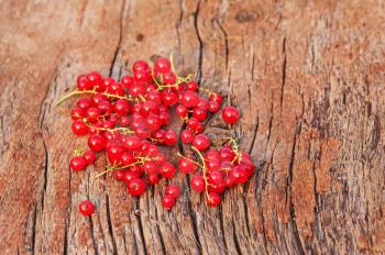 Sweet, red currant on wooden background. Closeup. Selective focus. 
