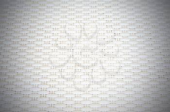 White cream plastic surface with repeating pattern. For use as background.