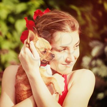 Cute Girl and Her Chihuahua Dog on Nature Background. With Retro Vintage Instagram Filter