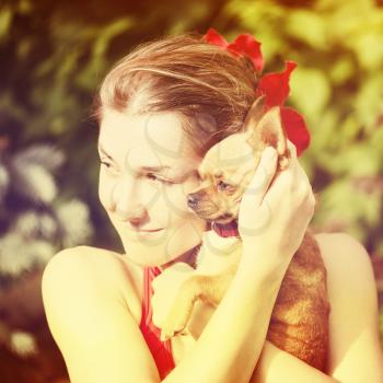 Cute Girl and Her Chihuahua Dog on Nature Background. With Retro Vintage Instagram Filter