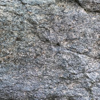 Untreated natural granite background texture wall. Closeup.