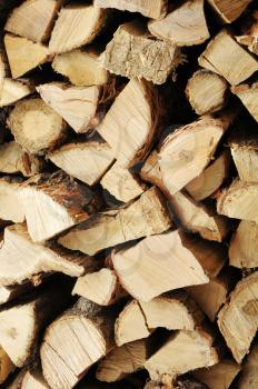 Dry chopped firewood logs in a pile. Nature abstract background with stack of firewood.