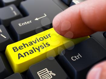 Behaviour Analysis Yellow Button - Finger Pushing Button of Black Computer Keyboard. Blurred Background. Closeup View.