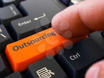 Outsourcing Concept. Person Click on Orange Keyboard Button. Selective Focus. Closeup View.
