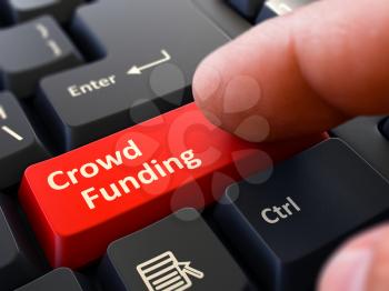 Crowd Funding - Written on Red Keyboard Key. Male Hand Presses Button on Black PC Keyboard. Closeup View. Blurred Background.