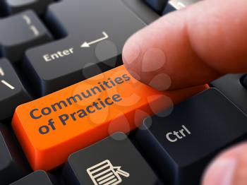Communities of Practice Orange Button - Finger Pushing Button of Black Computer Keyboard. Blurred Background. Closeup View.