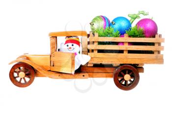 Small toy wooden truck loaded with christmas decoratios isolated on white