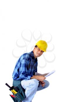  
Contractor kneeling with a blueprint isolated on white