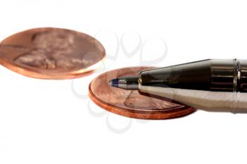Macro shot of a pen over a penny isolated on white