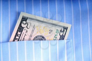 Five dollar bill into a shirts pocket