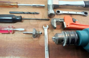 Several tools arranged over a wooden surface