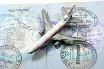 Small toy plane on a passport depicting travel